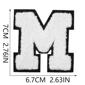 Close-up detail and dimensions of white chenille letter M patch for iron-on decoration