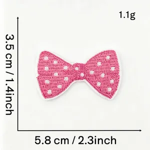Detail view of pink polka dot bow embroidered patch showing 5.8cm width and 1.1g weight