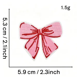 Detail of pink bow embroidered patch showing 5.9cm x 5.3cm dimensions and texture.