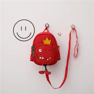 Mochila roja para niños con diseño de dinosaurio y correa de seguridad antipérdida