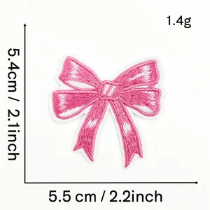 Detail showing measurements 5.5cm x 5.4cm and texture of pink embroidered bow patch