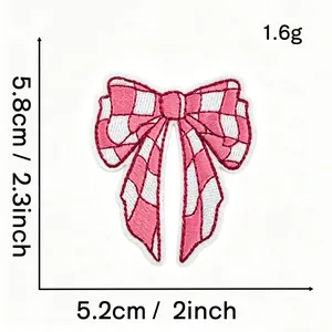 Detailed macro view of pink checkered bow embroidered patch showing precise dimensions and 1.6g weight