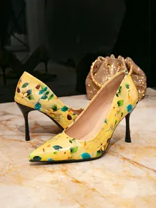 Detailed view of yellow floral print on fashionable pointed toe stiletto pumps