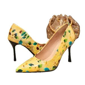 Stylish yellow floral pointed-toe stiletto pumps for women with elegant leaf patterns.