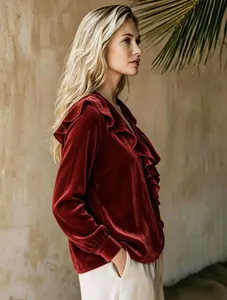Side view of elegant burgundy velvet V-neck blouse with ruffled details