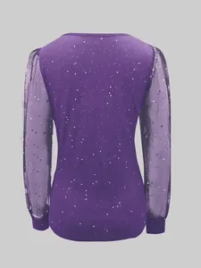 Back view of purple long sleeve top with starry mesh sleeves and glitter details