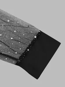 Detail view of elegant black T-shirt cuff with silver star mesh sleeve fabric