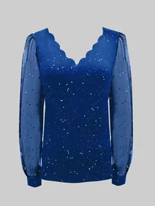 Detail view of the deep blue V-neck top with starry mesh sleeves and scalloped neckline.