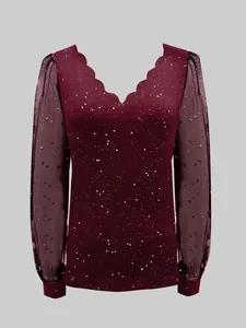 Detailed view of the burgundy V-neck top featuring sheer mesh sleeves with star patterns