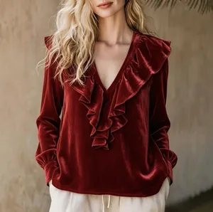 Elegant burgundy velvet V-neck blouse with feminine ruffle trim and long sleeves