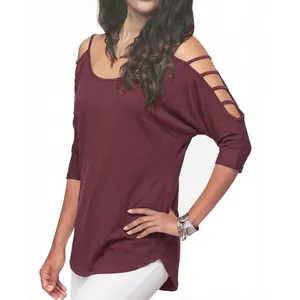 Close-up detail of maroon cold-shoulder t-shirt with unique ladder strap sleeve design