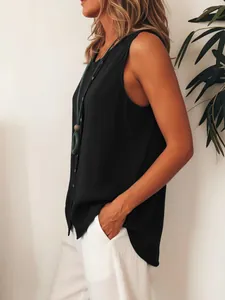 Side view of a woman wearing a black sleeveless button-down loose fit tank top