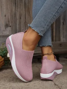 Detail view of pink breathable fly-woven slip-on sneakers with air cushion sole