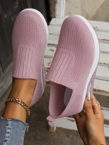 Detail of breathable pink flyknit slip-on sneakers for women with cushioned thick sole