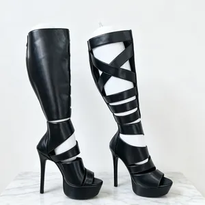 Detailed side view of black strappy high heel gladiator boots with platform heels