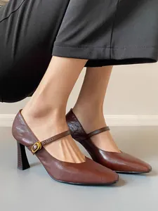 Brown leather Mary Jane high heels with an elegant strap and chunky heel detail.