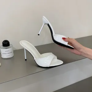 Elegant white patent leather high heel mules featuring a slim stiletto and round toe design