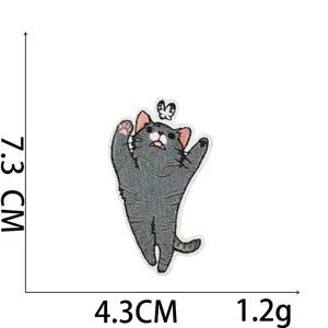 Detailed view of grey cartoon cat embroidery patch with 7.3cm x 4.3cm size markings