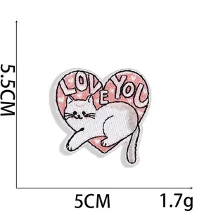 Close-up of heart-shaped white cat embroidery patch with Love You text details