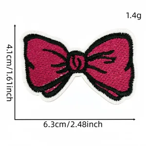 Detailed view of pink bow embroidery patch with size measurements 6.3x4.1cm