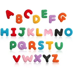 Detailed macro view of 26 colorful chenille alphabet embroidery patches for DIY projects