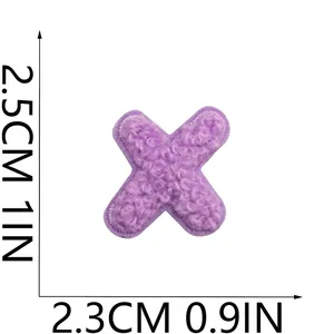 Detail view of purple chenille embroidered letter X patch measuring 2.5cm by 2.3cm