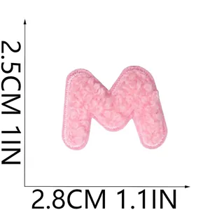 Pink chenille letter M embroidered patch detail showing 2.5cm by 2.8cm dimensions