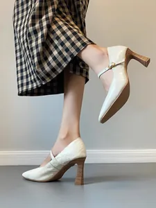 Close-up of elegant French style off-white leather Mary Jane block heel shoes