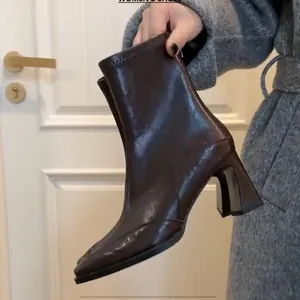 Elegant dark brown leather ankle boots with square toe and high block heel.