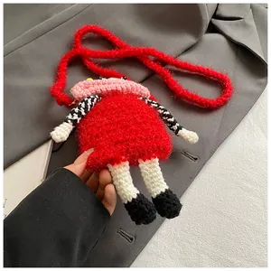 Detailed macro view of a handmade red crochet crossbody bag featuring a funny big mouth