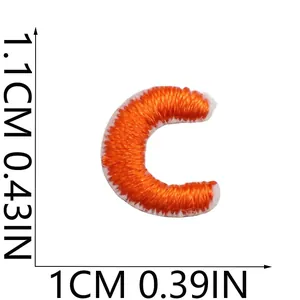 Detailed view of mini orange embroidered letter C patch with 1.1cm by 1cm dimensions