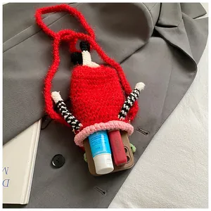 Detailed view of the red handmade knitted crossbody bag showing internal storage capacity