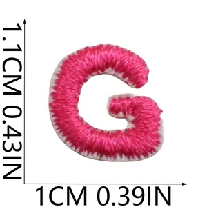 Detailed macro view of a mini pink embroidered letter G patch with size dimensions