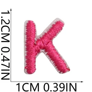 Detailed size view showing dimensions of a pink embroidered letter K patch at 1.2 x 1 cm