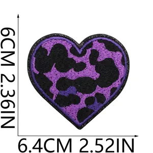 Close-up of heart embroidered patch with purple leopard pattern and size markings