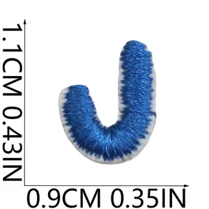 Detailed view of mini blue embroidered letter J patch with size markings in cm and inches