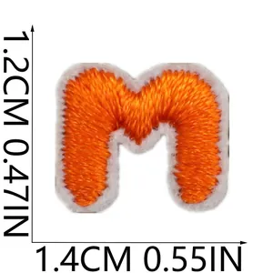 Detail view of small orange embroidered letter M patch with precise size measurements.