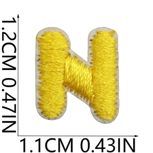 Yellow embroidered letter N patch detail with 1.2cm x 1.1cm precise size markings