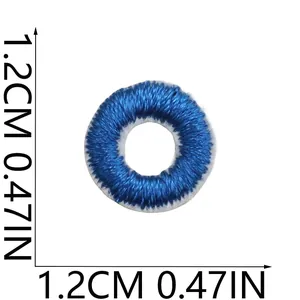 Close-up of small round blue embroidered patch showing 1.2cm diameter measurement detail