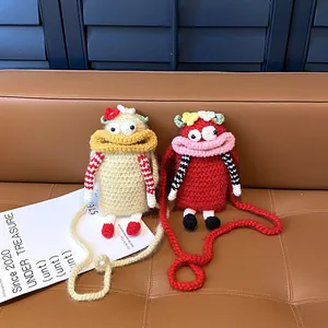 Handmade crochet monster crossbody bag featuring a funny big mouth and cute flower accents