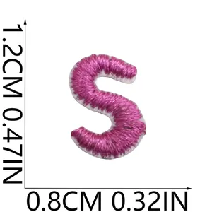 Detailed view of a mini pink embroidered letter S patch with 1.2cm x 0.8cm dimensions