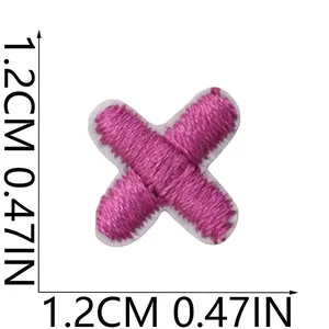Pink embroidered cross patch detail shown with 1.2cm x 1.2cm dimensions for DIY