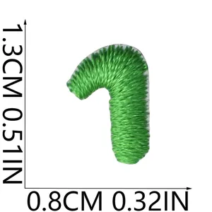 Detailed close-up of mini green embroidered number 1 patch with dimension markings