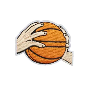 High-quality basketball theme embroidery patch with hands holding a ball for clothing decoration