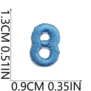 Detailed view of a mini blue embroidered number 8 patch showing size 1.3cm by 0.9cm