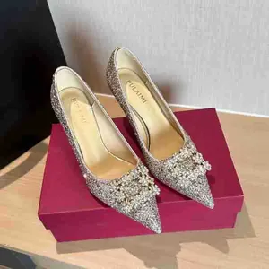 Close-up of champagne glitter high heels with luxury crystal buckle on red box
