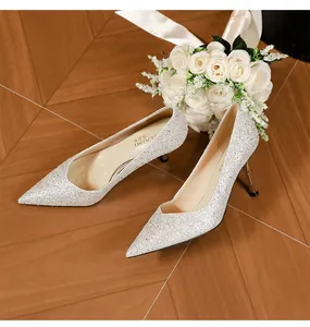 Close-up of silver glitter high heels with pointed toe and stiletto for bridal weddings