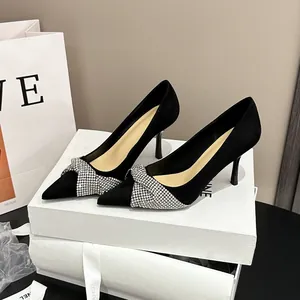 Elegant black suede pointed toe high heel pumps featuring a sparkling rhinestone bow