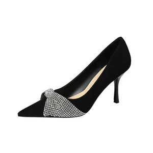 Elegant black suede stiletto pumps featuring a sparkling rhinestone bow detail.