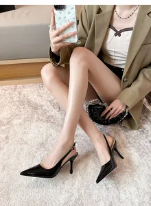 Elegant black patent leather pointed-toe slingback stiletto heels shown on model